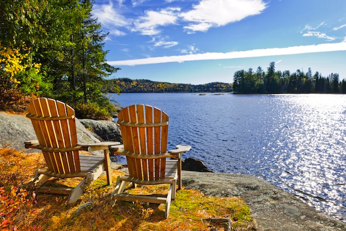 Chairs by a lake at a romantic Ontario resort in Muskoka