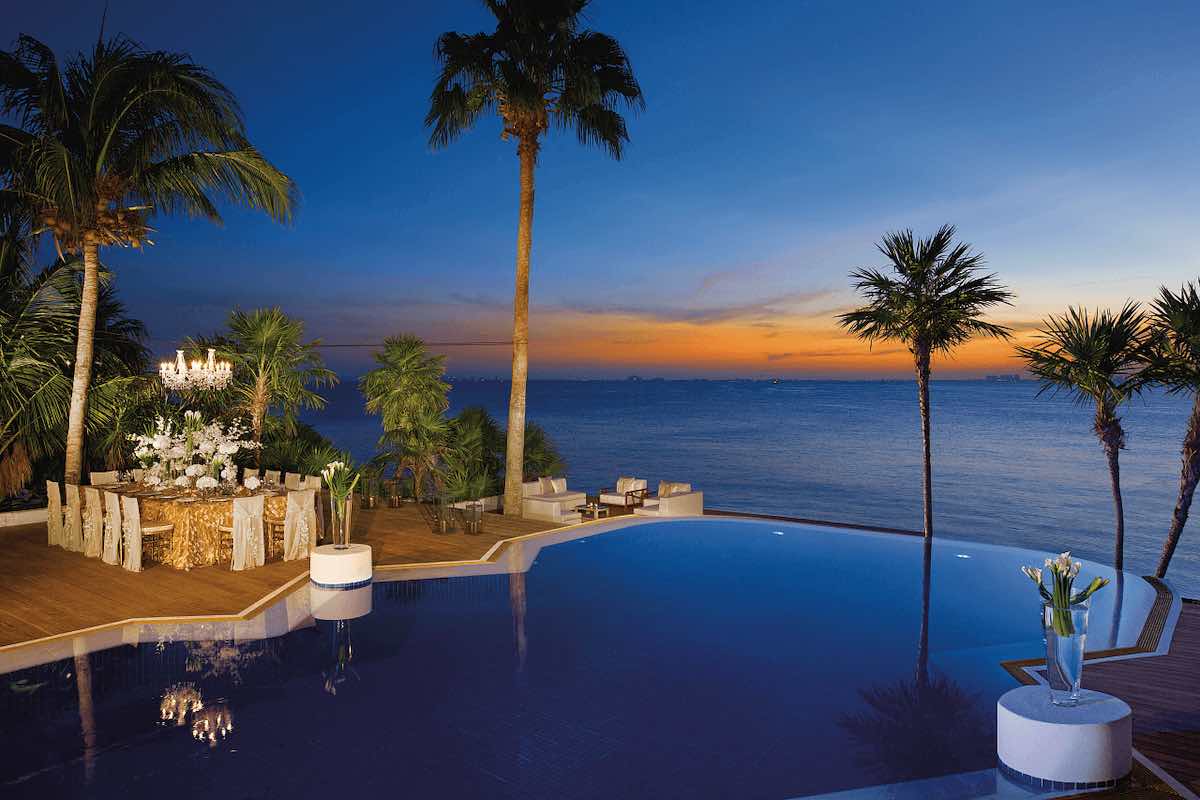 zoetry mexico all inclusive resort pool at sunset