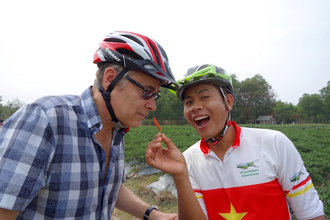 two men in bike helmuts laughing