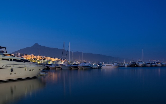 Yachts at dusk in the water.