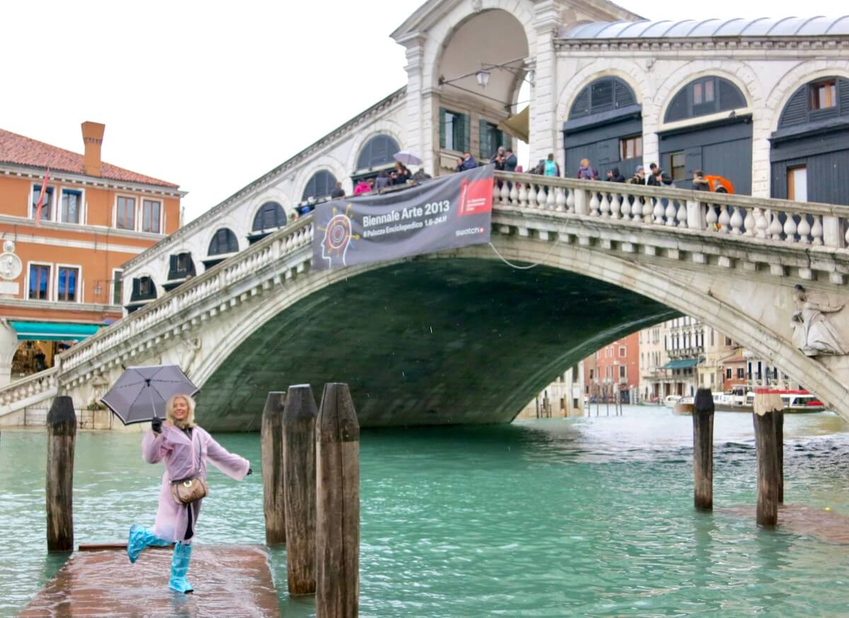 Venice in the rain with Wandering Carol with umbrella at Rialto Bridge