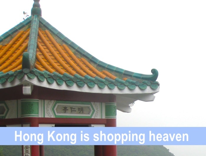 Victoria Peak in fog, Hong Kong with the text 'Hong Kong is shopping heaven'