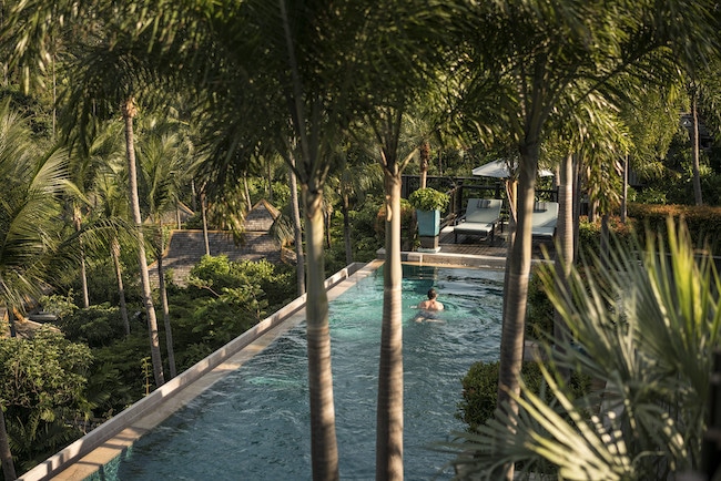 Lush outdoor pool at Four Seasons Koh Samui, one of the best beach resorts in Thailand