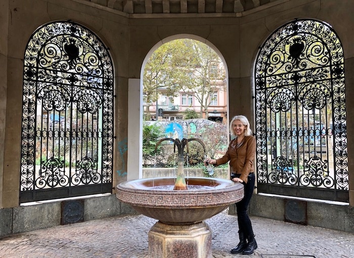 Wandering Carol drinking mineral water in Wiesbaden