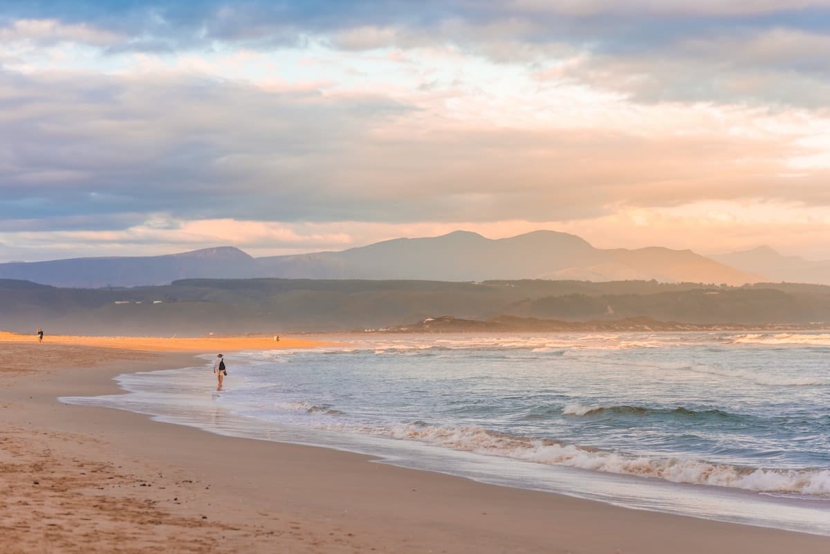 pale pink sunset photo of plettenberg bay beach