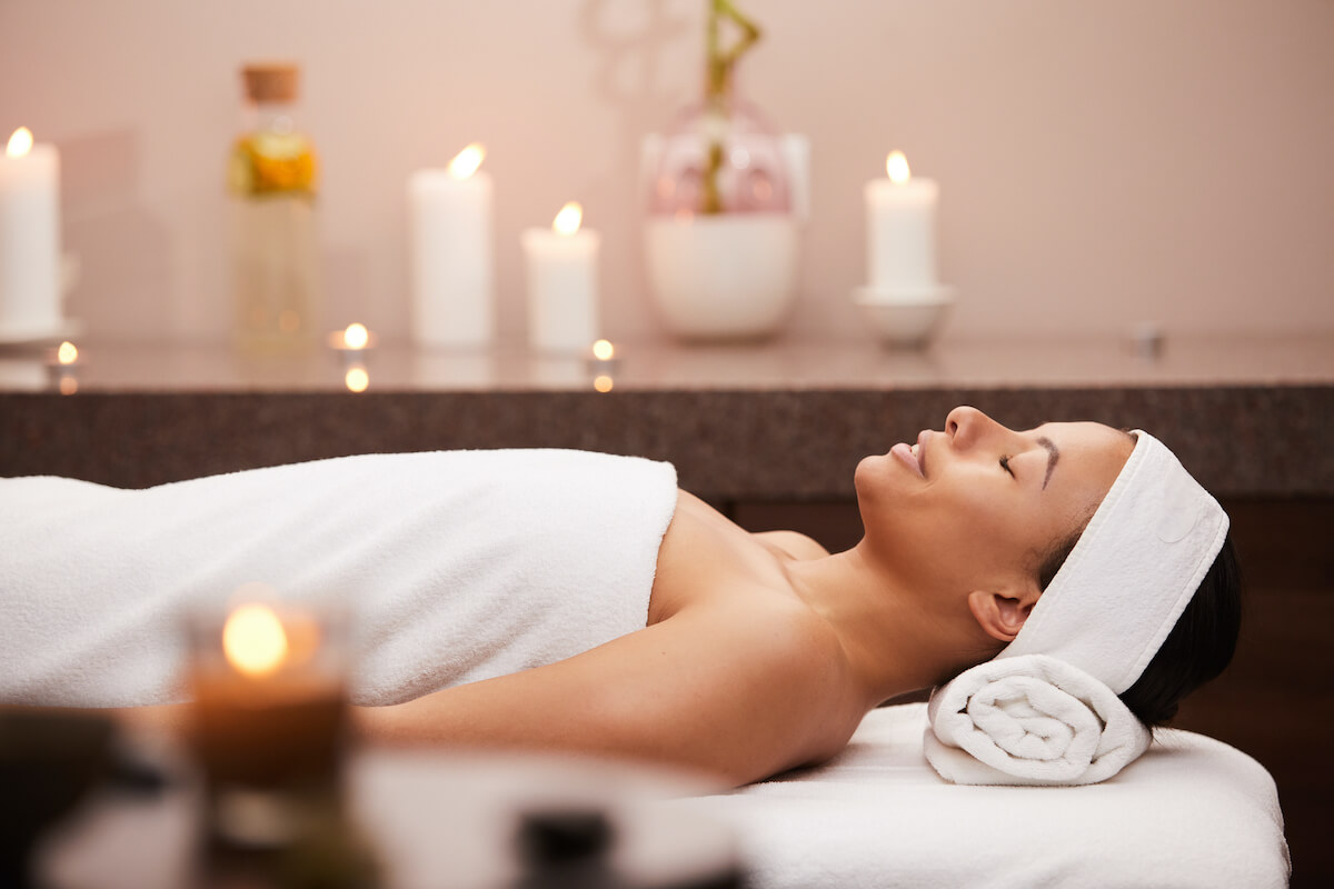 woman lying on a massage table at a day spa