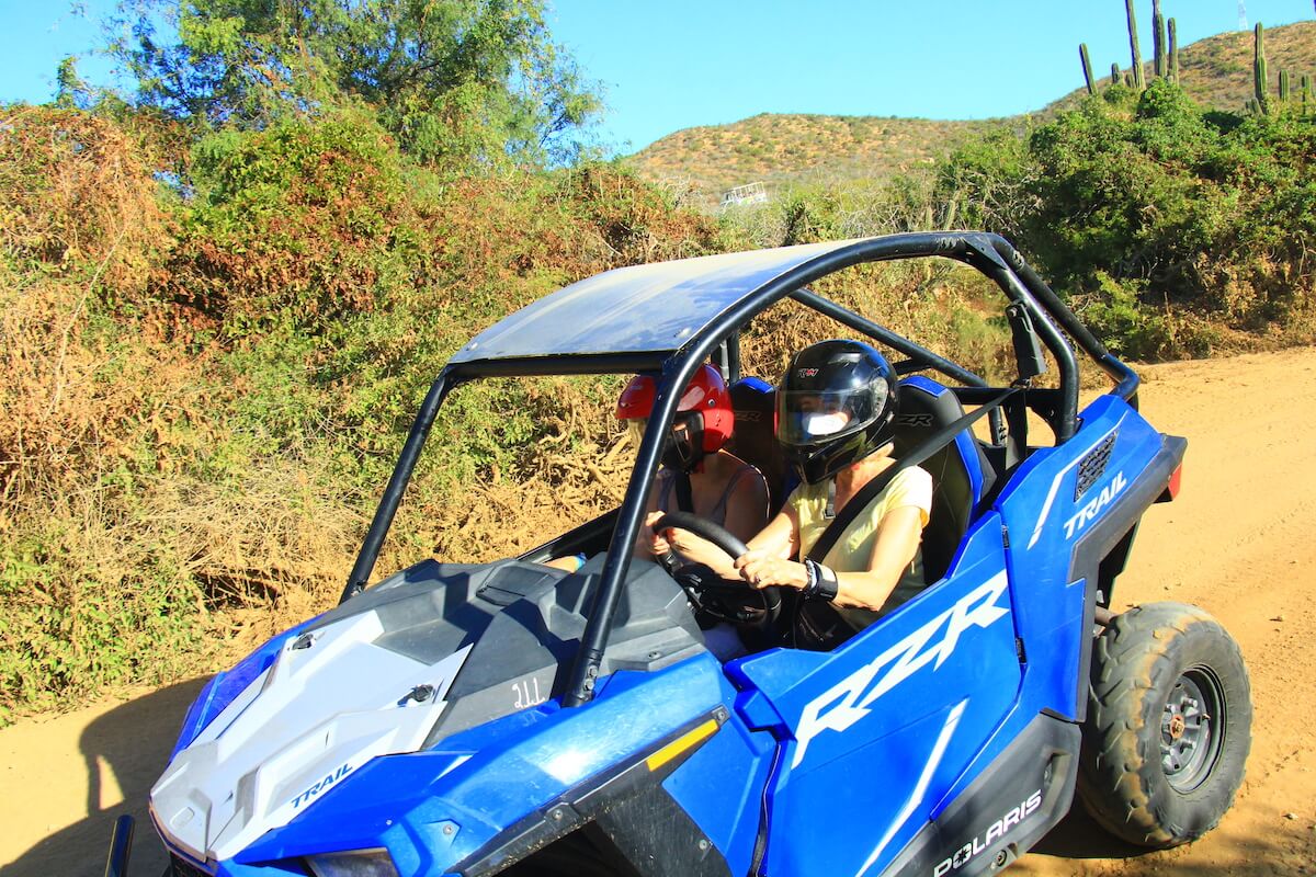 Going downhill on a Cabo ATV tour in a bright blue RZR UTV