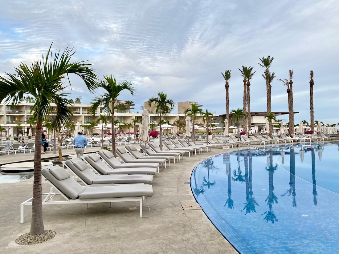 Quiet pool with beige lounge chairs