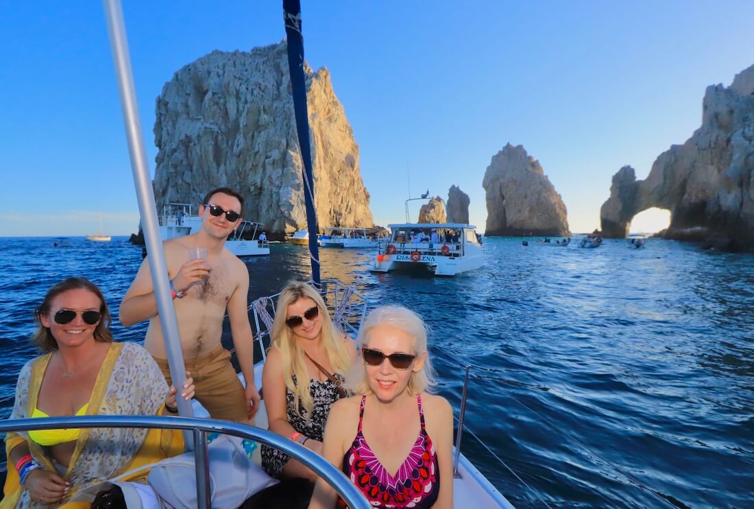 People posing on a sunset cruise to the Arch in Cabo San Lucas