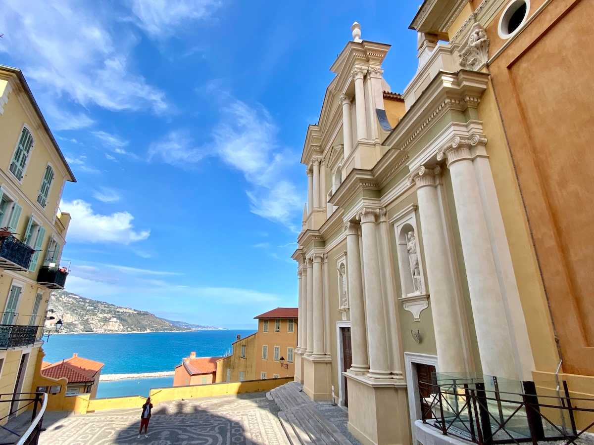 Church in Menton with blue sky behind.