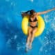woman on yellow float in pool