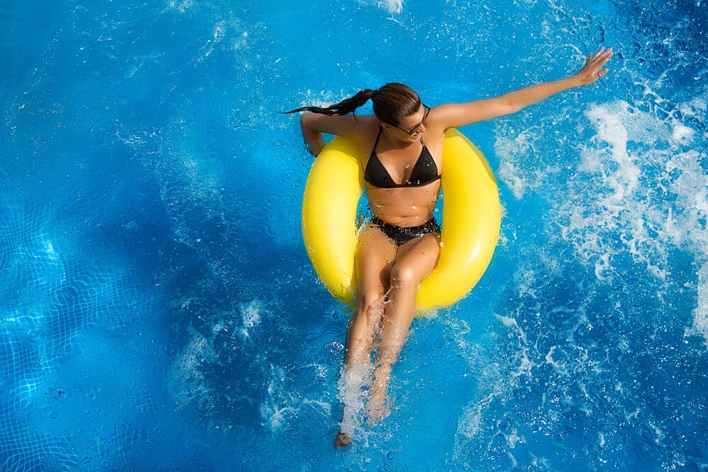 woman on yellow float in pool