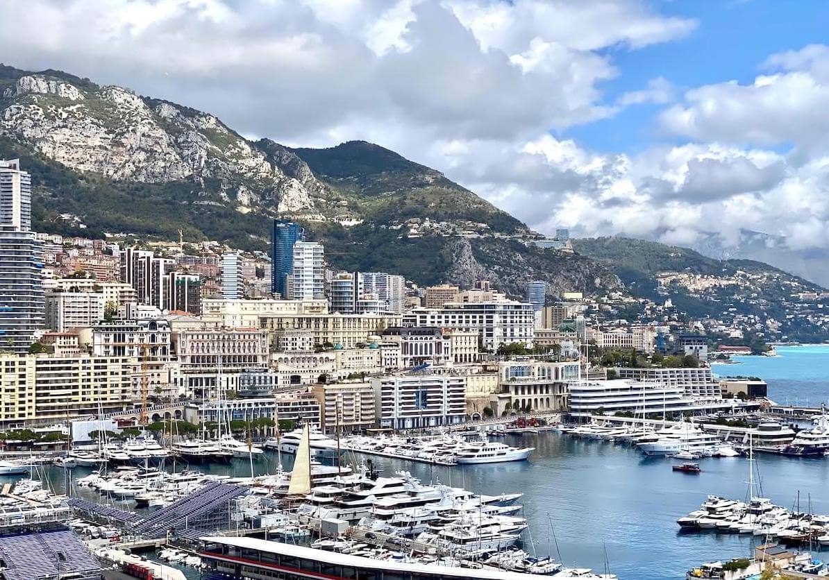 Panoramic shot of Monaco with yachts, mountains and sea