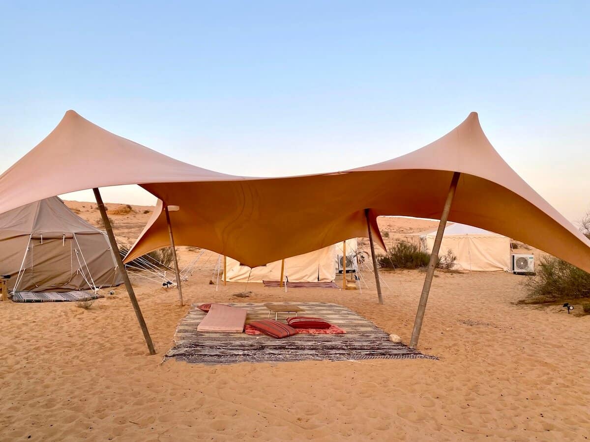 Beige sun umbrellas on sand in the desert