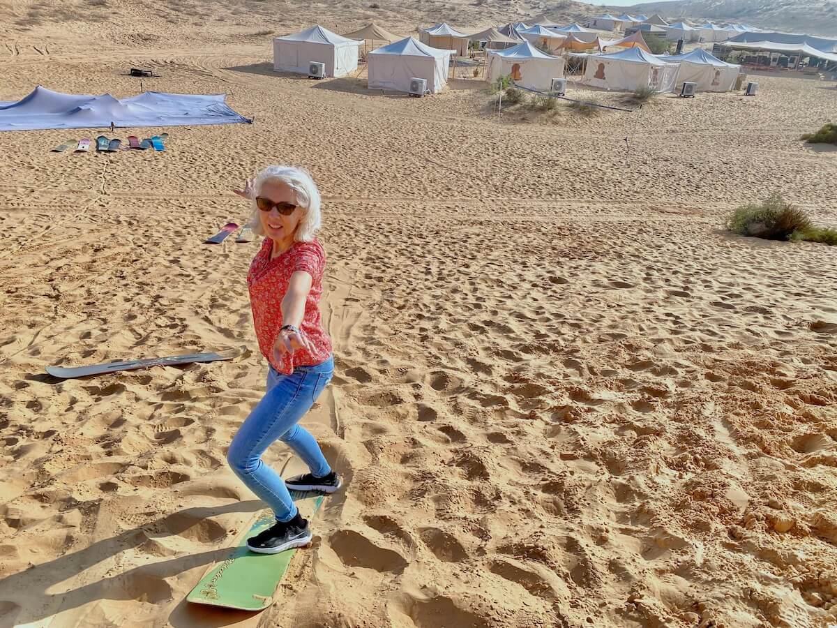 Carol Perehudoff sand boarding in the Israeli desert