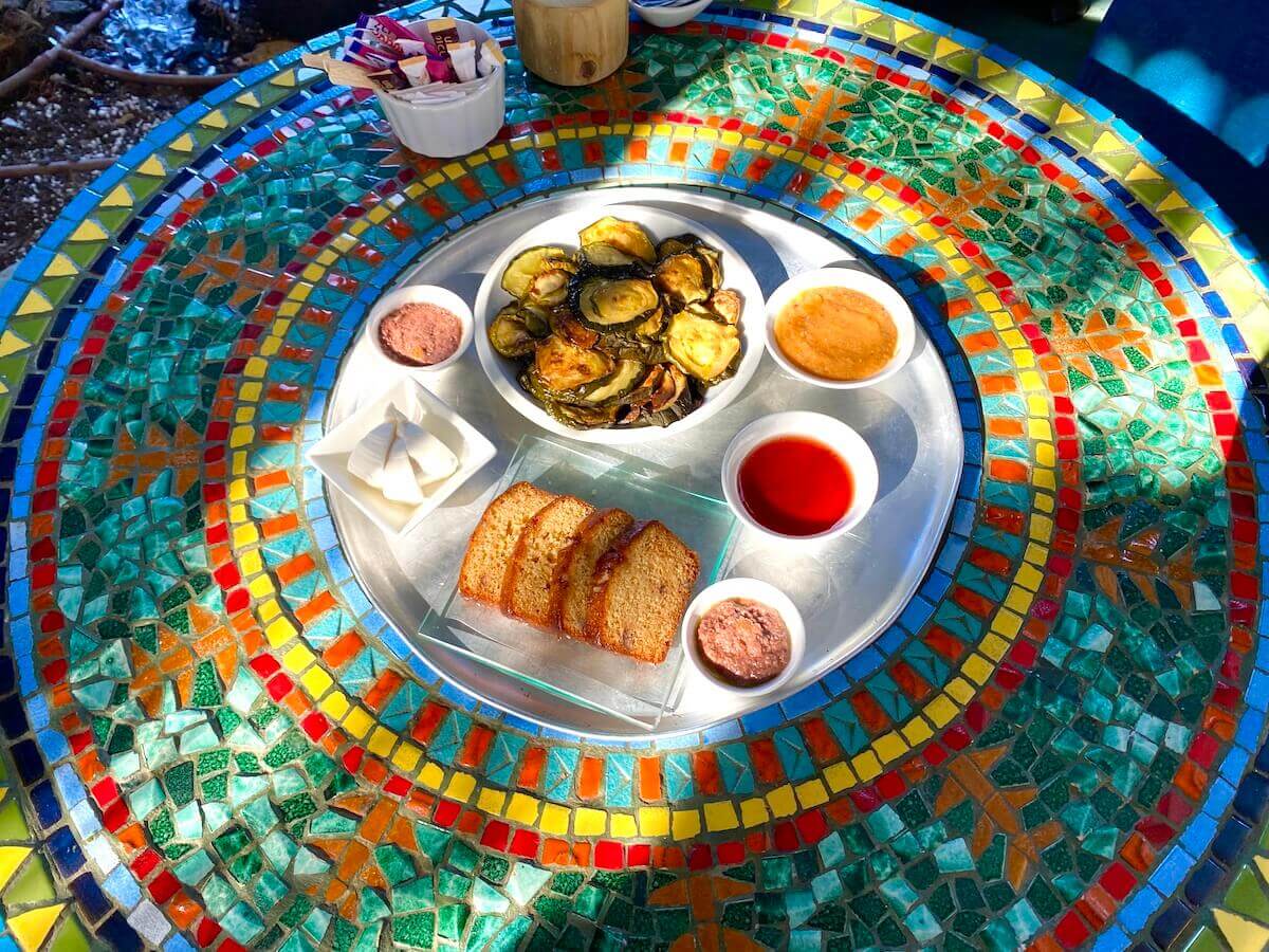 Israeli food on a mosaic table at Carmey Farm