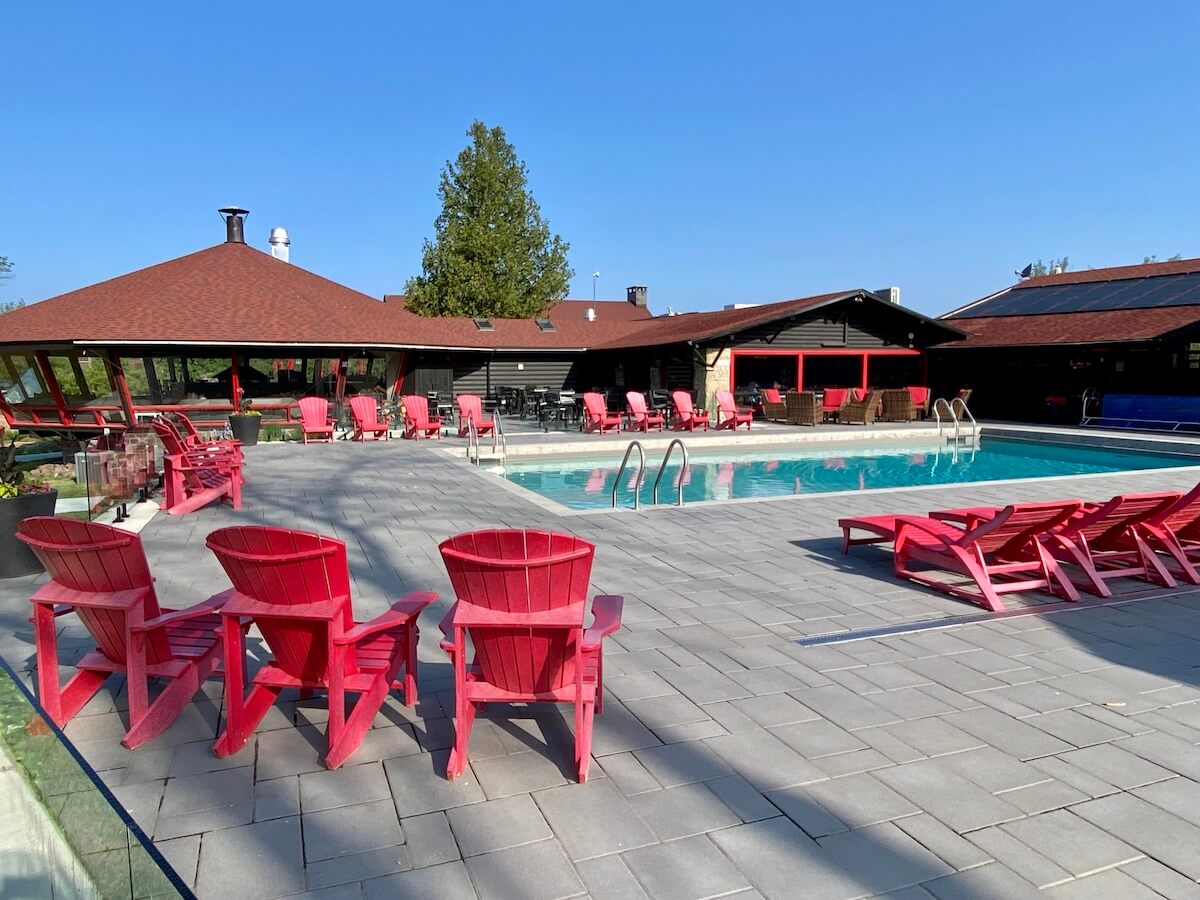 Outdoor pool with red deck chairs