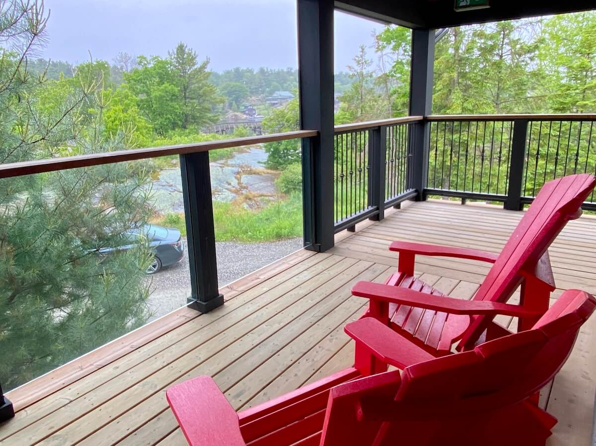 Two red chairs on a balcony at a luxury resort in northern Ontario
