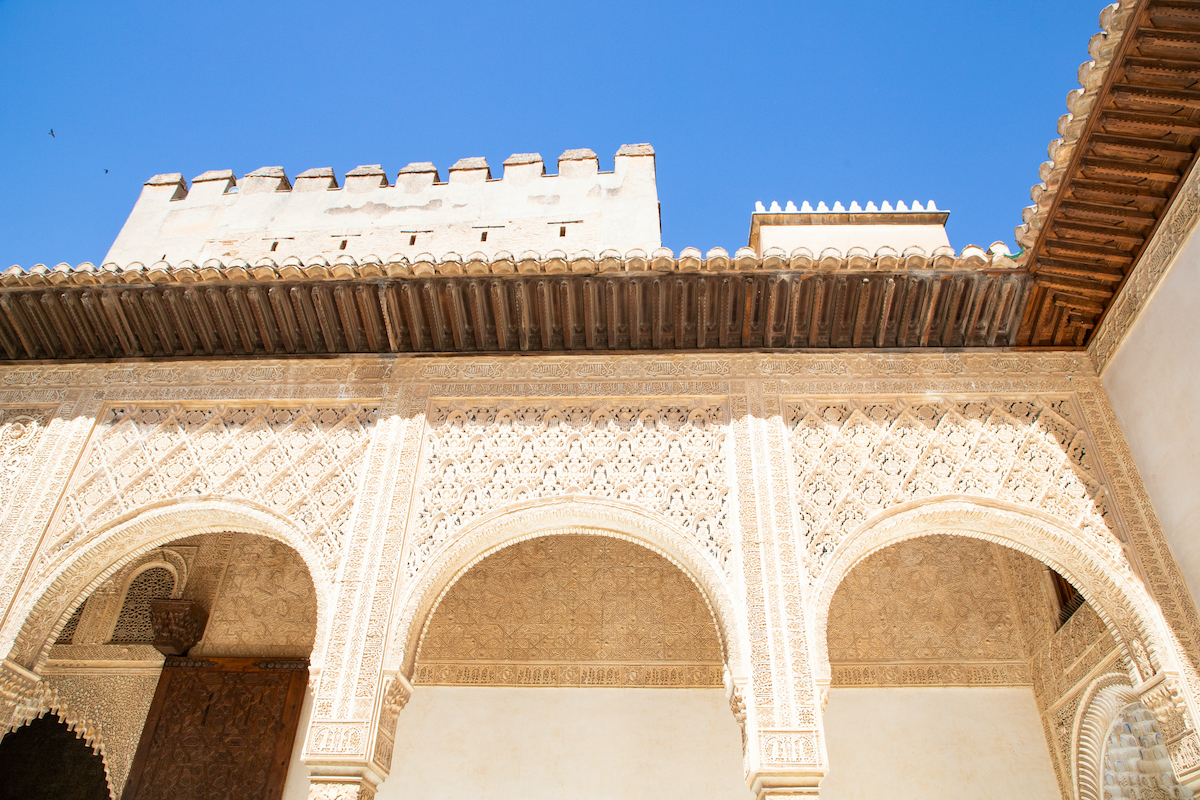 Pale walls and arches at Alhambra in Grenda, Spain.