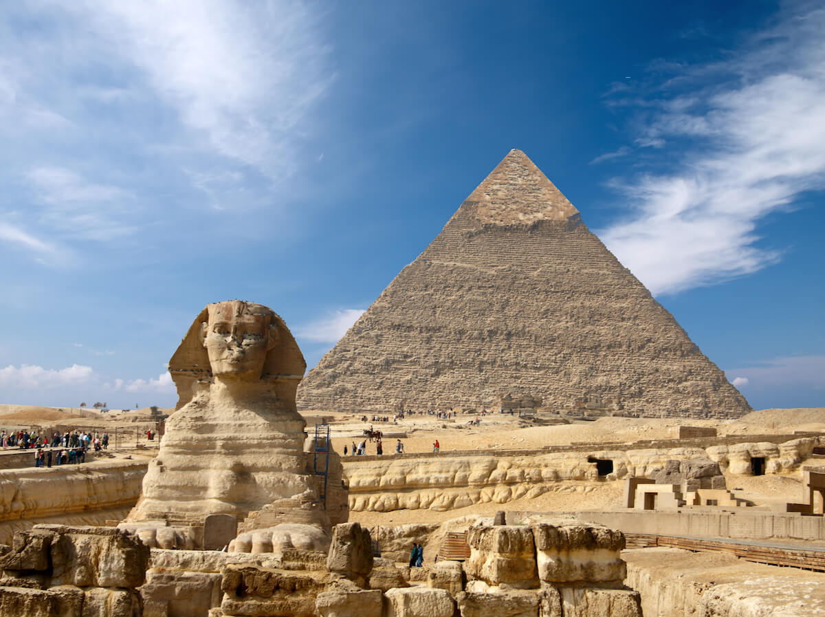 The Sphinx in front of a pyramid. 