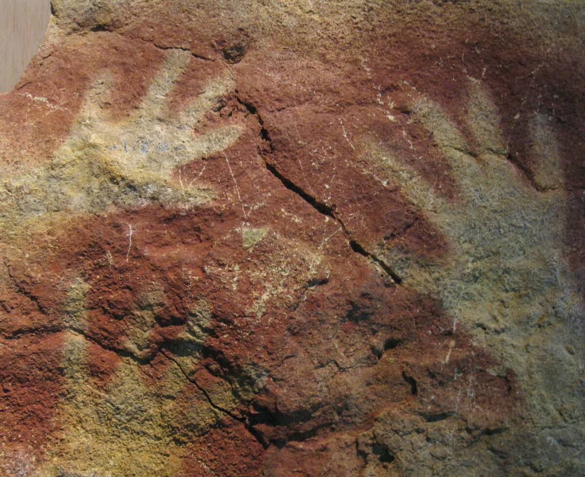 Primitive cave painting of hands.