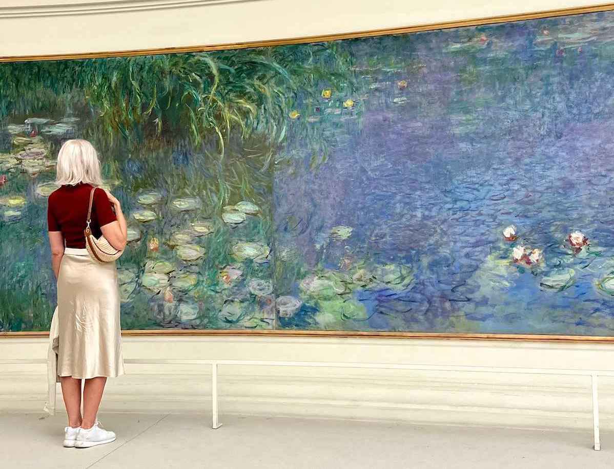 Carol Perehudoff looking at Monet paintings in Paris.