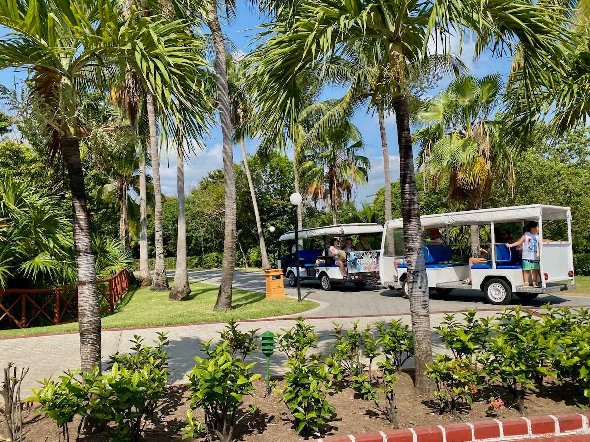 Open air trolleys on the lush grounds of Grand Bahia Principe.